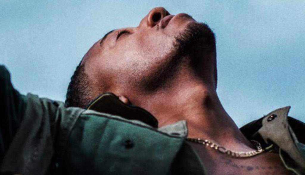 Christian rapper Lecrae's latest album shows him lifting arms up and looking toward the sky in a prayerlike pose.